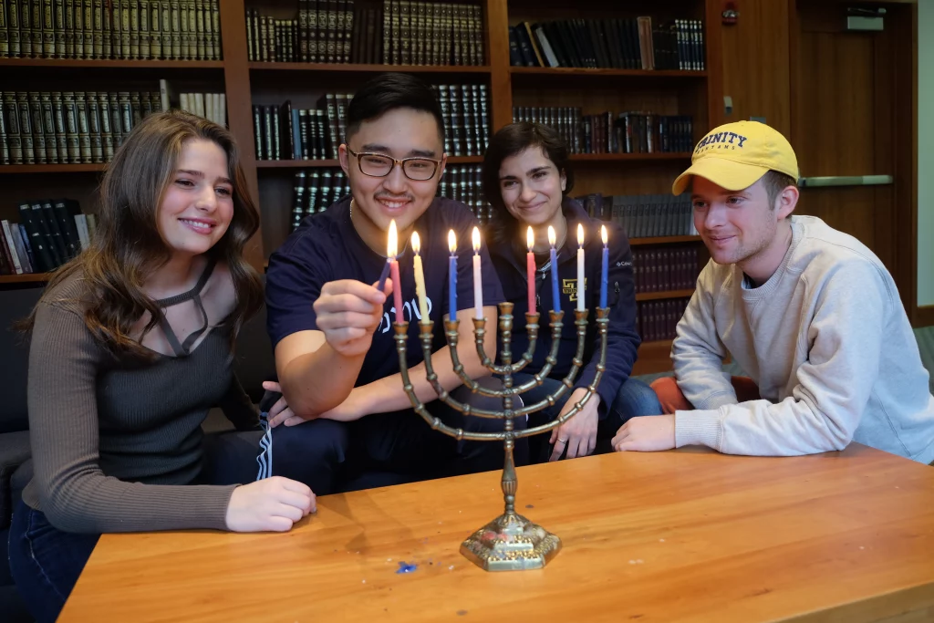 Students lighting Hanukkah candles together
