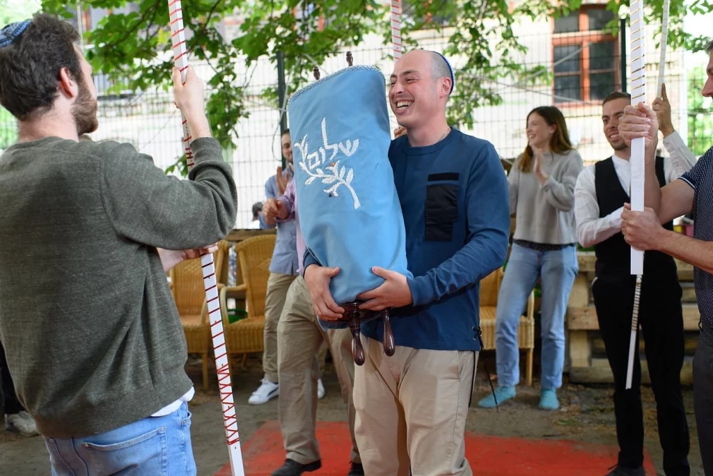 Jewish students, professionals, and community members gather at Hillel Deutschland to celebrate its new Torah scroll.